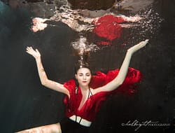 Lizzie Gunst poses underwater in red