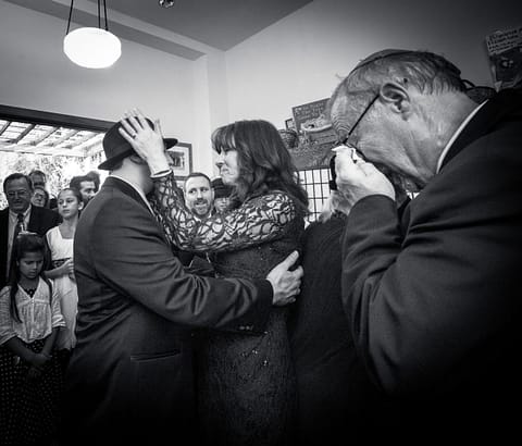 Mother of groom hugs her son while the father wipes away tears - Jewish Wedding - Congregation Beth Israel - Wedding