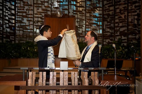 Bar Mitzvah and his father undress the torah at Temple Peninsula Sholom Burlingame