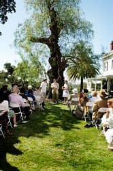 Bride and Groom standing in front of beautiful tree in front of friends and family for their wedding ceremony - Napa Wedding