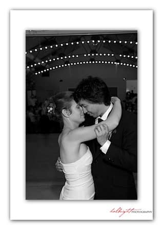 Bride and Groom have their first dance under string lights - Camp Arroyo Wedding